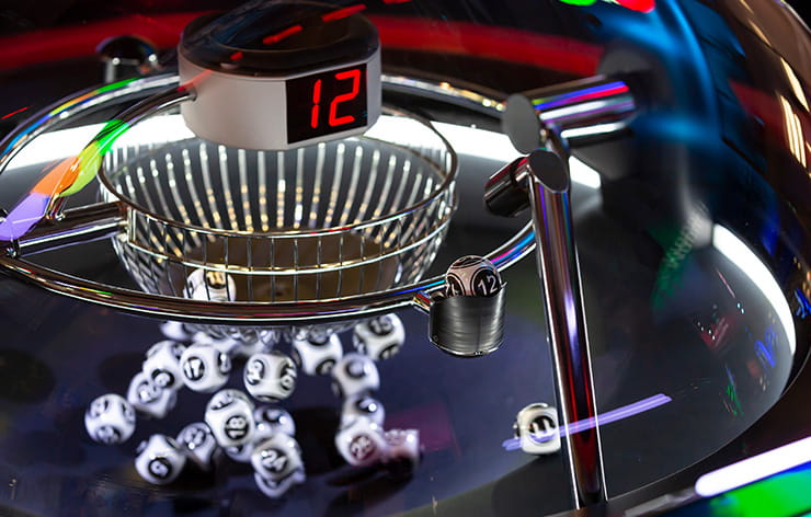A lottery machine with balls inside, and a winning number 12